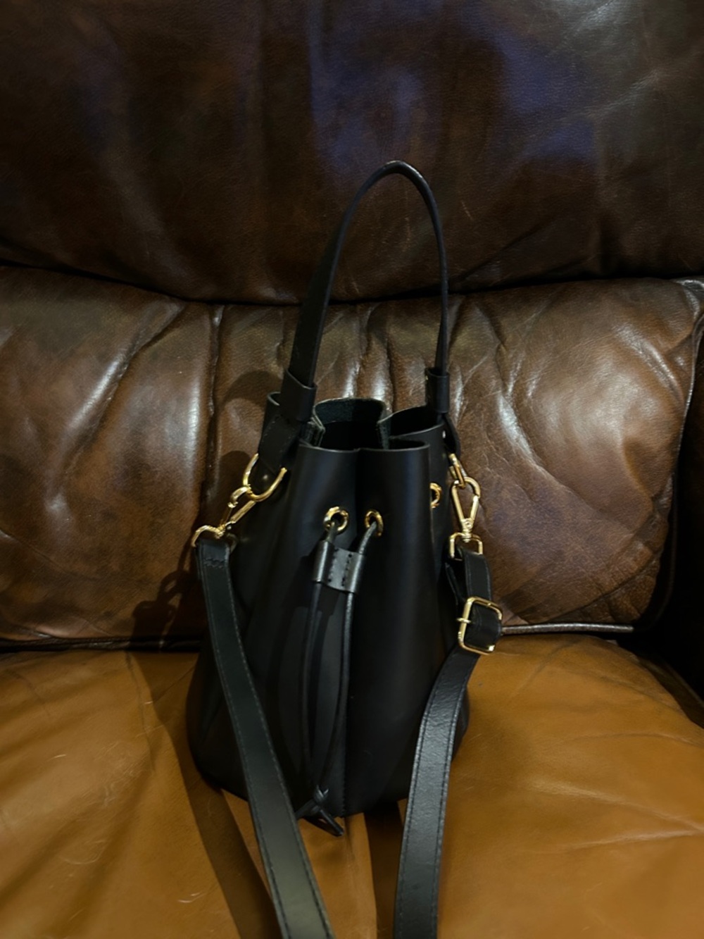 Able Black Leather Drawstring Bucket Crossbody Bag with Gold Hardware